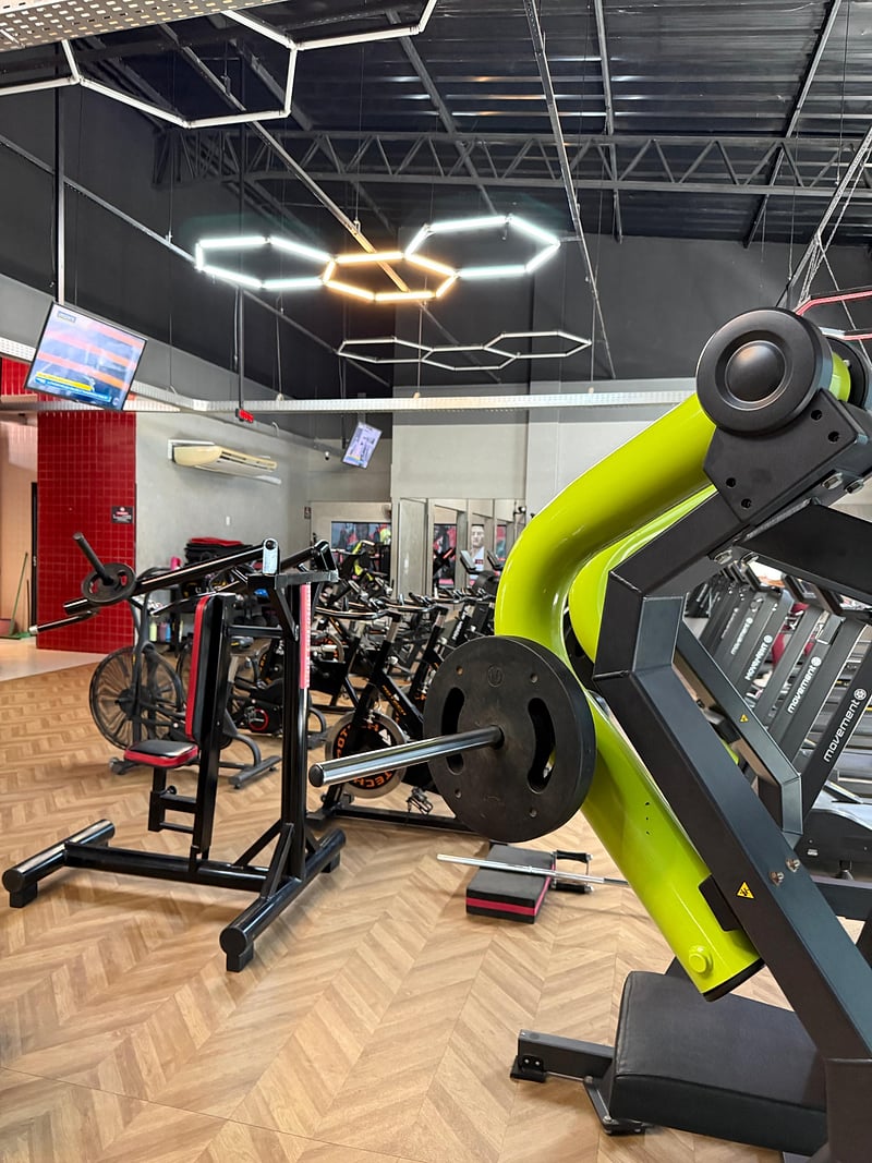 Sala de musculação da Impacto Academia, em Barras-PI, com aparelhos e iluminação hexagonal